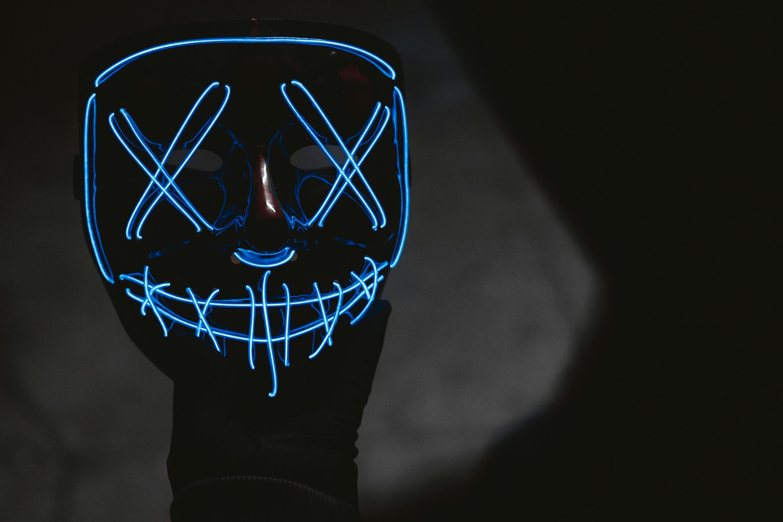 A black LED face mask with glowing blue lights creating a eerie design, perfect for Halloween.